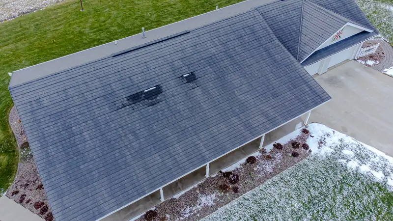 Aerial view of a shingle roof with vents on a ranch house